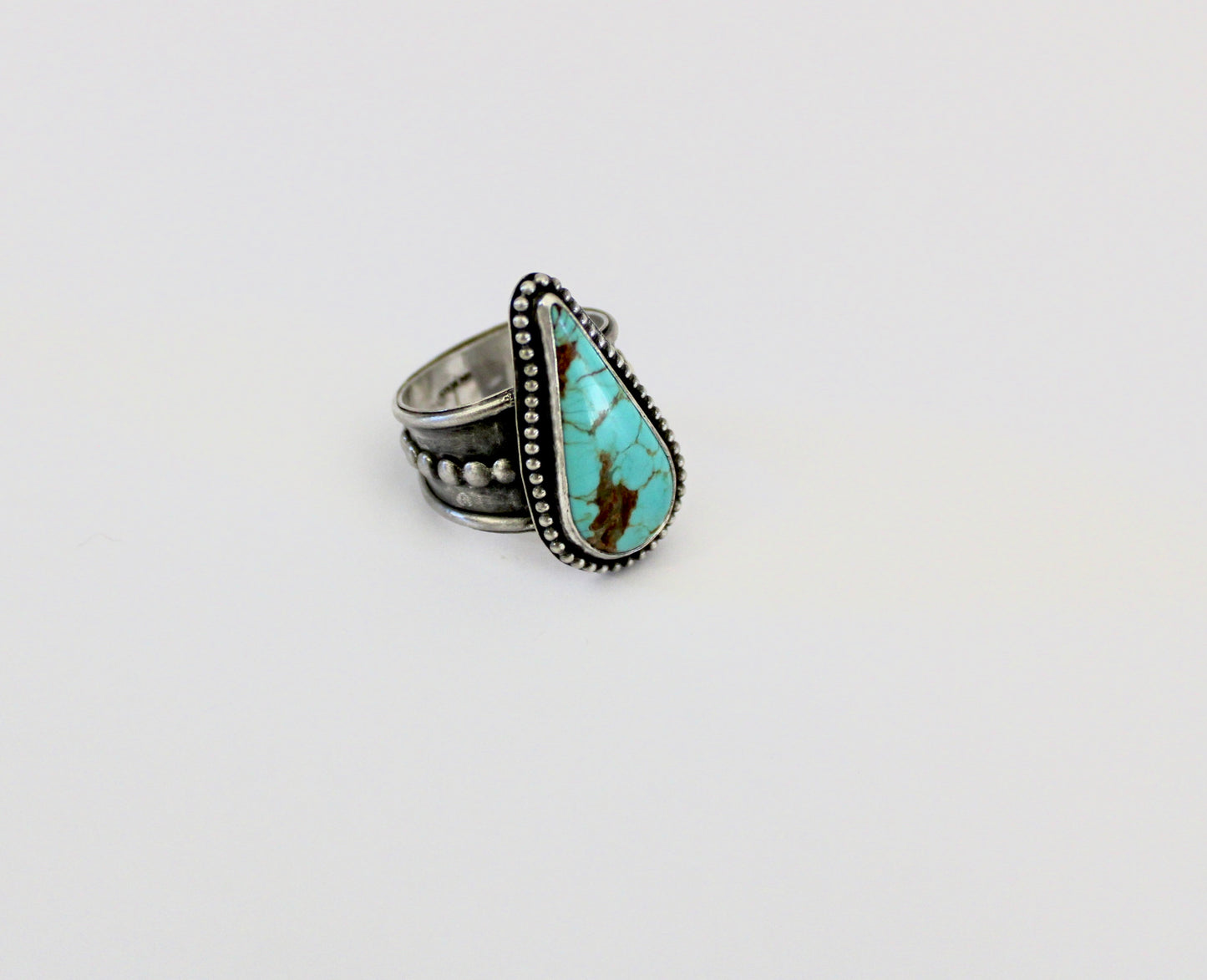Number 8 Turquoise ring on a beaded ring Shank. Size 10 1/2.