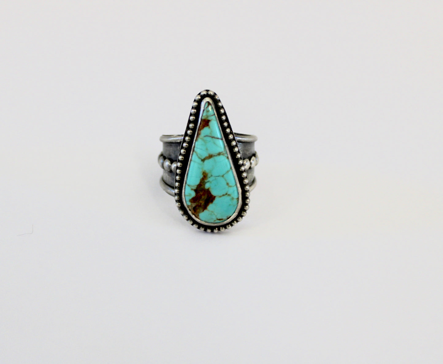 Number 8 Turquoise ring on a beaded ring Shank. Size 10 1/2.