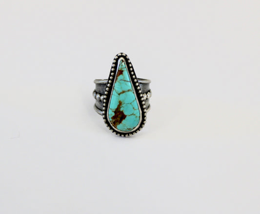 Number 8 Turquoise ring on a beaded ring Shank. Size 10 1/2.